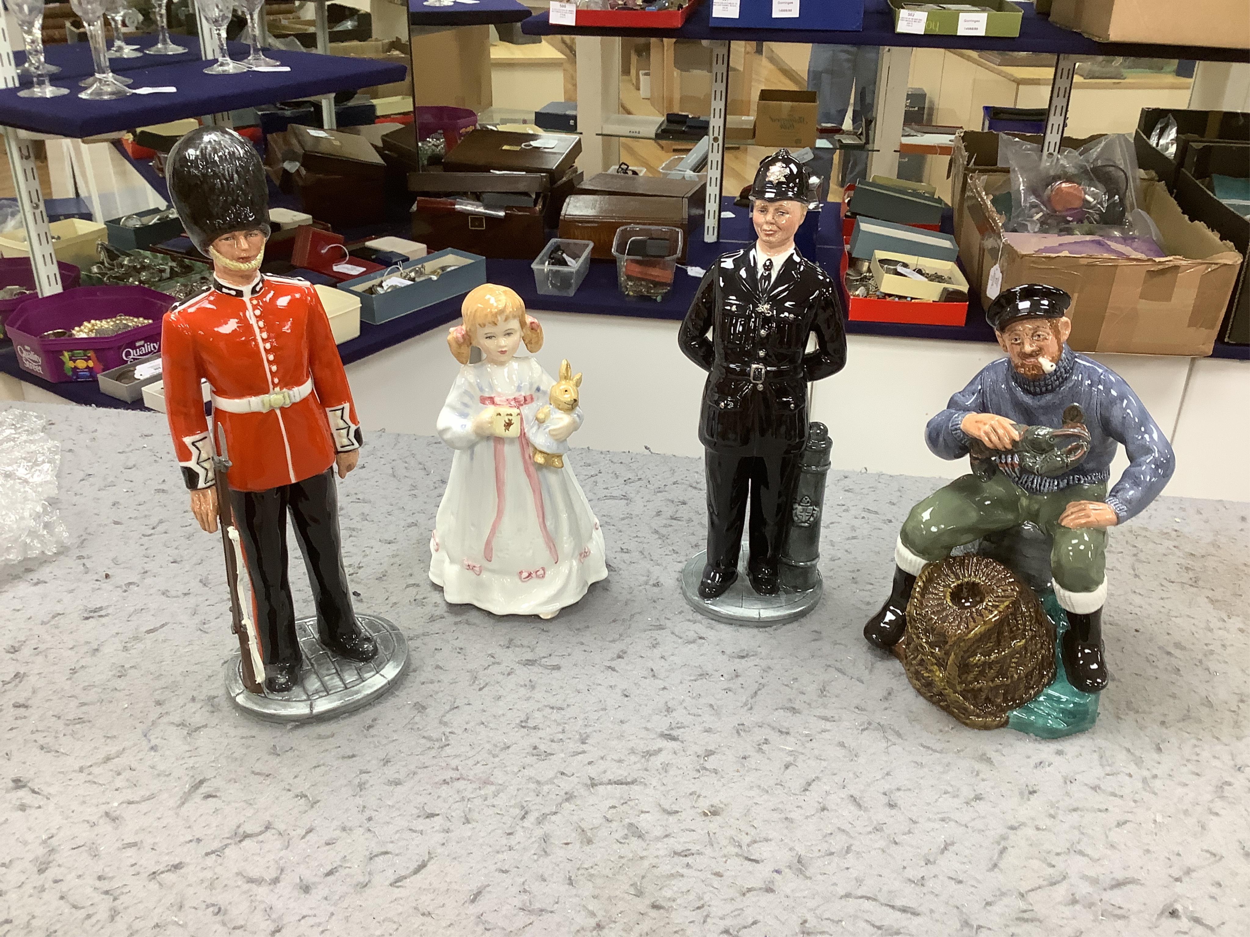 Six Royal Doulton figures including Bunny’s Bedtime, The Guardsman and The Lifeguard, together with a Christopher Columbus Toby jug, all boxed, Guardsman 25cm high. Condition - fair to good